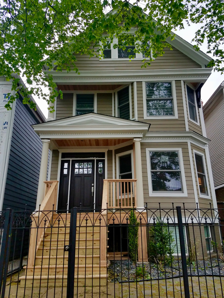 Medium sized and brown victorian two floor detached house in Chicago with concrete fibreboard cladding and a shingle roof.