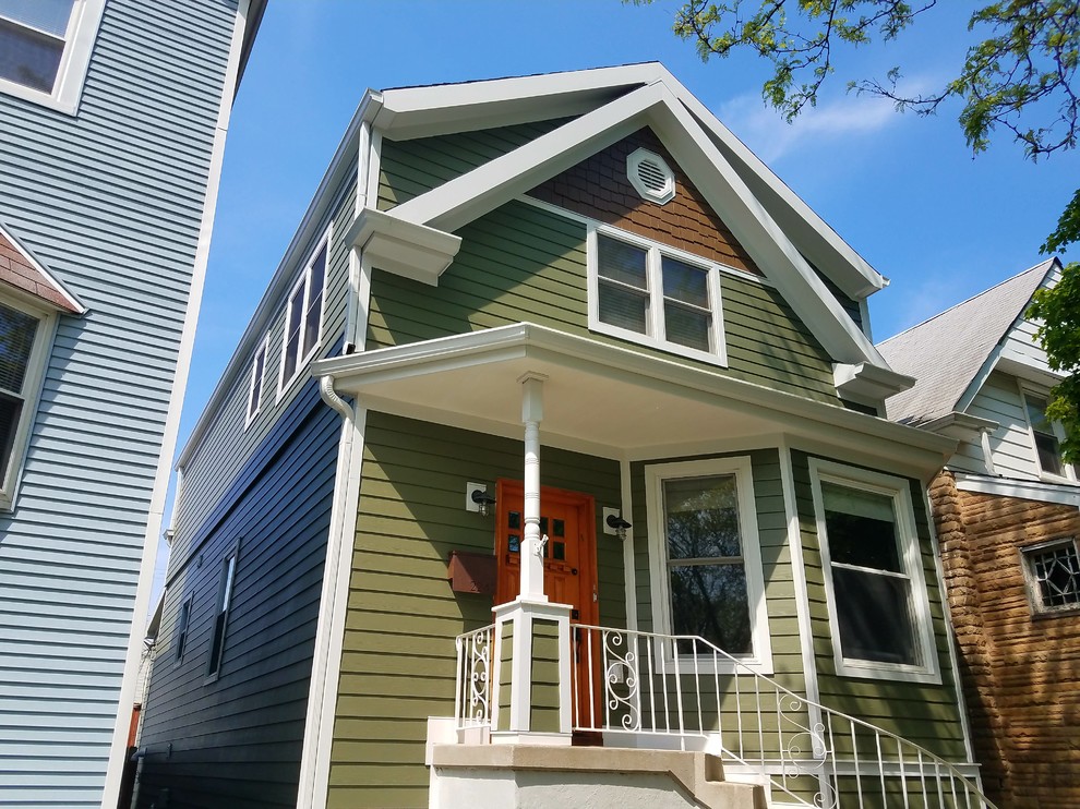 Example of a mid-sized ornate green three-story concrete fiberboard exterior home design in Chicago with a shingle roof