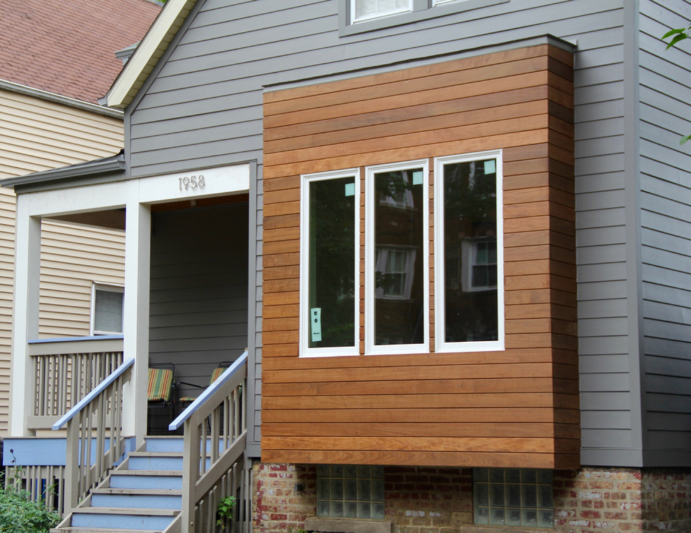 Diseño de fachada de casa gris minimalista de tamaño medio de dos plantas con revestimiento de aglomerado de cemento, tejado a dos aguas y tejado de teja de madera