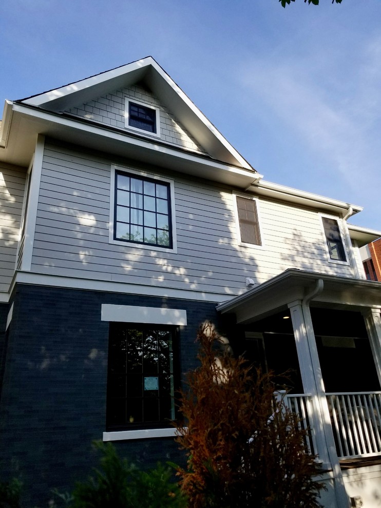 This is an example of a medium sized and beige classic two floor detached house in Chicago with mixed cladding, a pitched roof and a shingle roof.