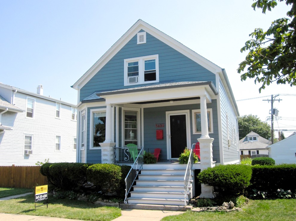 Mid-sized cottage blue two-story concrete fiberboard exterior home photo in Chicago with a shingle roof