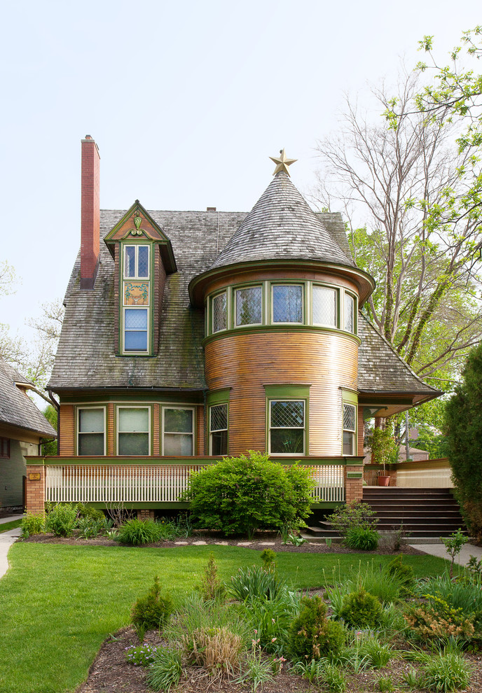 Brown and medium sized victorian detached house in Chicago with wood cladding, three floors, a shingle roof and a brown roof.