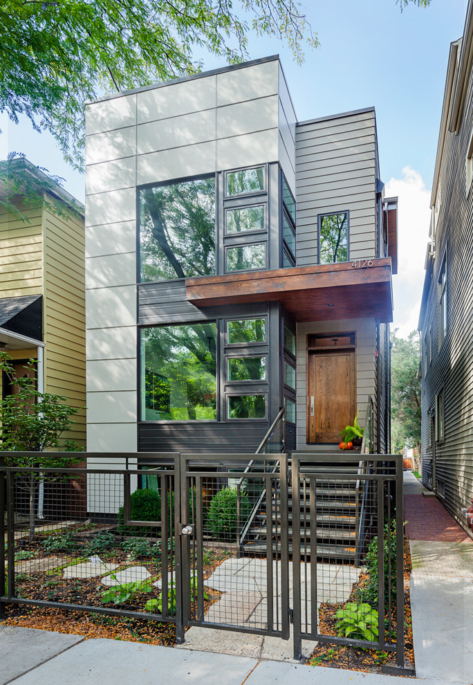 Idée de décoration pour une petite façade de maison design en panneau de béton fibré à deux étages et plus.