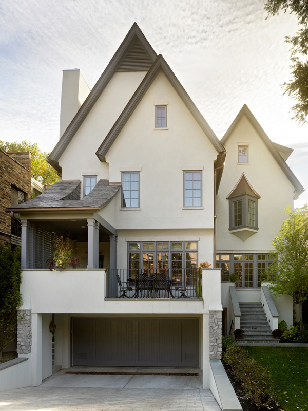Mid-sized traditional beige three-story stucco gable roof idea in Chicago