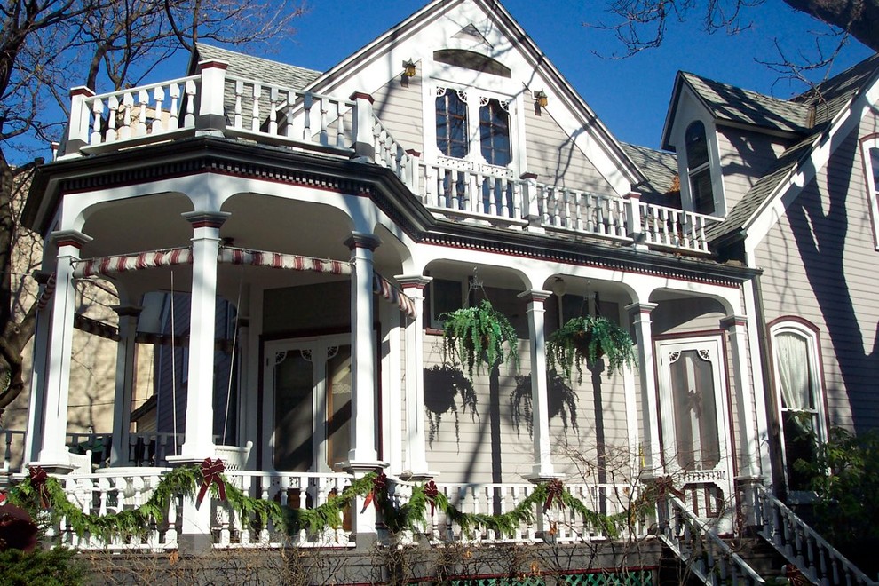 Design ideas for a victorian house exterior in Chicago with wood cladding.