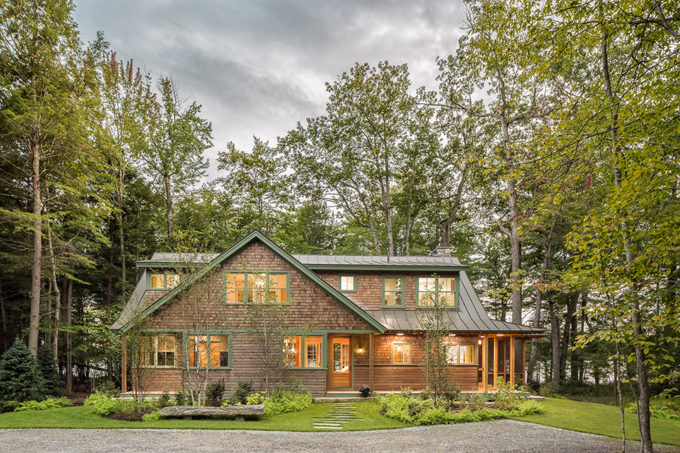 Mountain style brown two-story wood exterior home photo in Portland Maine with a metal roof