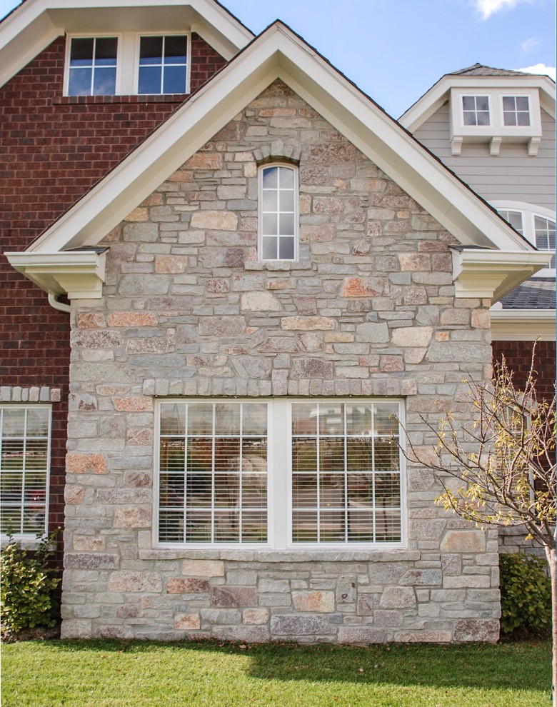 Photo of a traditional house exterior in Chicago with stone cladding.