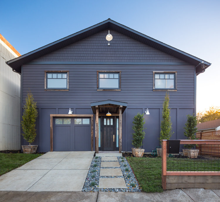 Large industrial two floor house exterior in San Francisco with wood cladding, a pitched roof and a purple house.