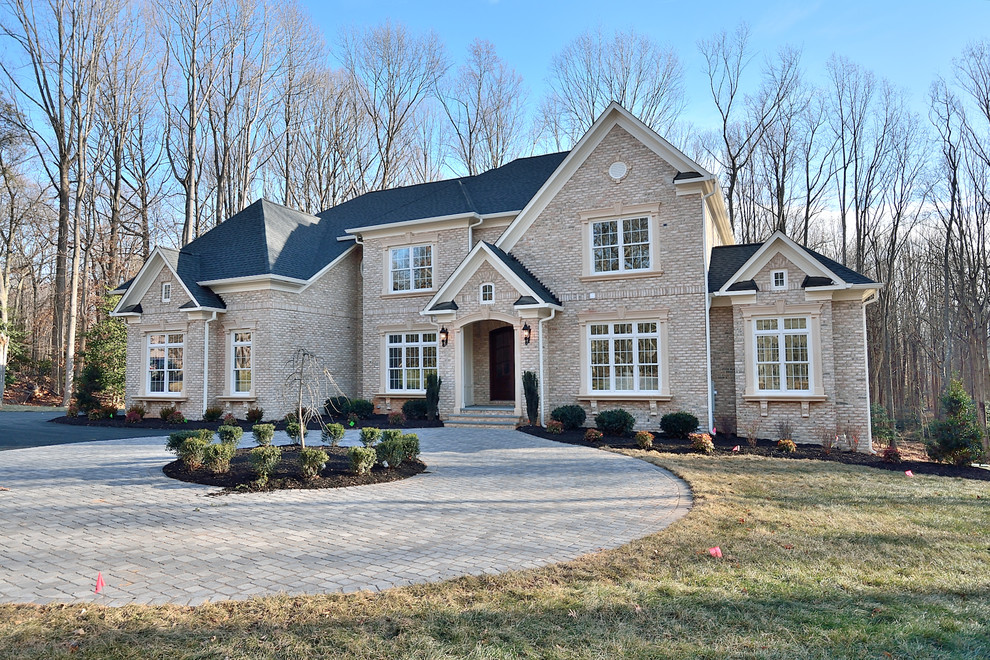 Huge transitional beige three-story brick house exterior idea in DC Metro with a hip roof and a shingle roof