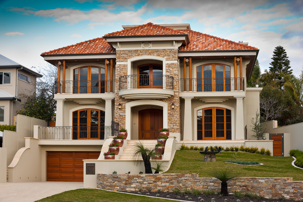 Example of a tuscan beige three-story stucco house exterior design in Perth with a hip roof and a tile roof