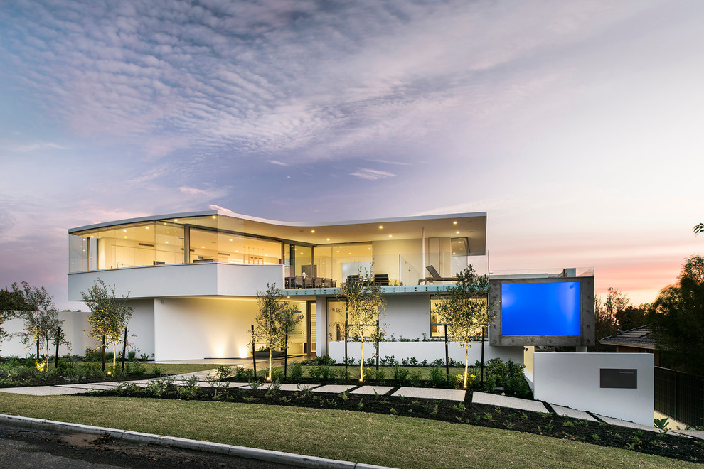Example of a huge minimalist white three-story exterior home design in Perth