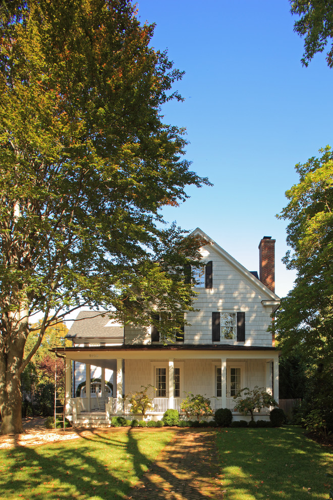 Foto della facciata di una casa country a due piani con rivestimento in legno