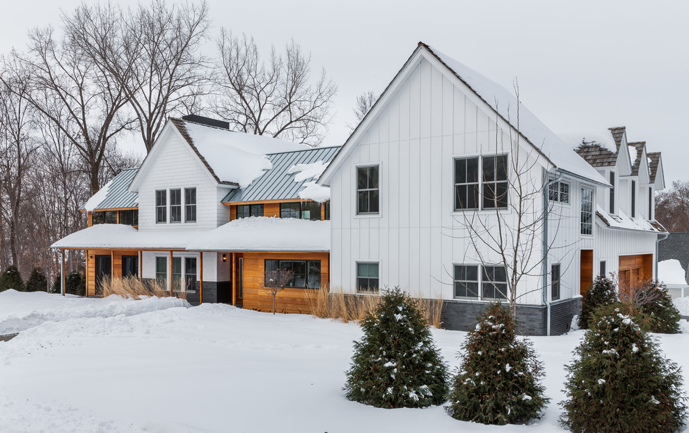 This is an example of a white classic two floor house exterior in Minneapolis with concrete fibreboard cladding.