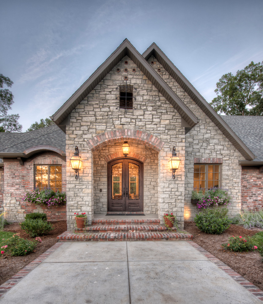 Example of a huge transitional beige one-story stone exterior home design in Other with a shingle roof