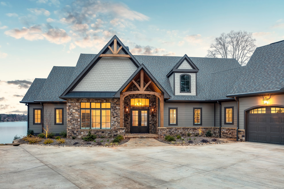 Medium sized and gey rustic bungalow detached house in Other with mixed cladding and a shingle roof.