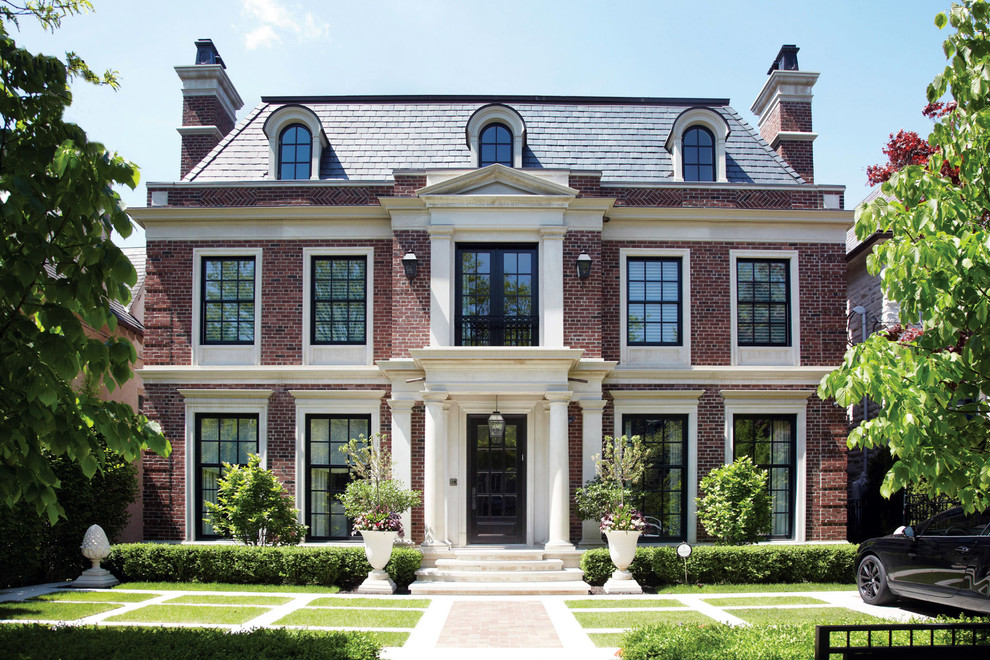 Elegant brick exterior home photo in Toronto with a hip roof