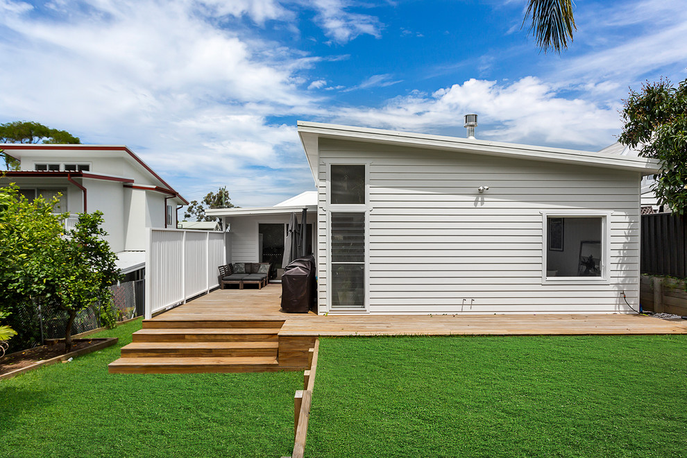 Example of a beach style one-story exterior home design in Wollongong with a metal roof