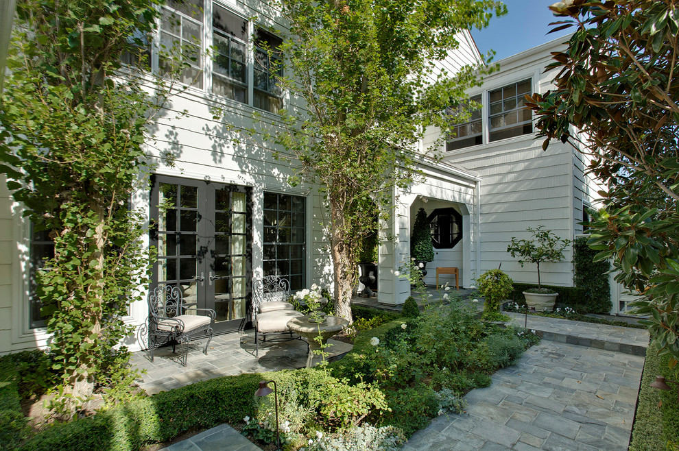 Inspiration for a mid-sized timeless white two-story vinyl exterior home remodel in Orange County