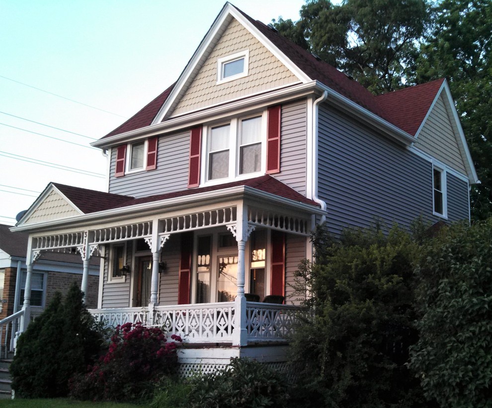 Inspiration for a large and gey victorian two floor house exterior in Chicago with vinyl cladding and a pitched roof.