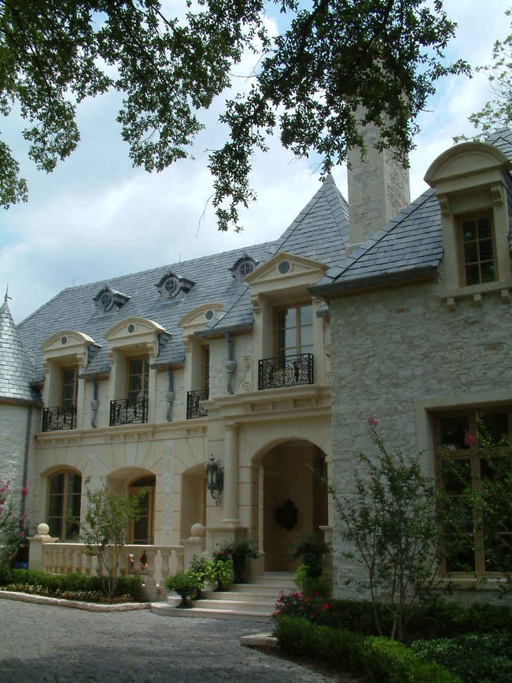 This is an example of a large and multi-coloured victorian two floor detached house in Dallas with stone cladding, a hip roof and a shingle roof.