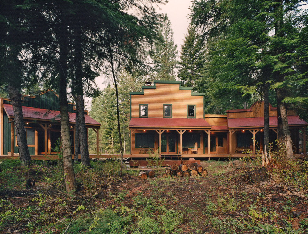 Example of a mid-sized mountain style two-story wood exterior home design in Seattle