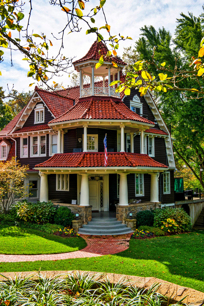 Example of a large ornate brown three-story wood gable roof design in DC Metro