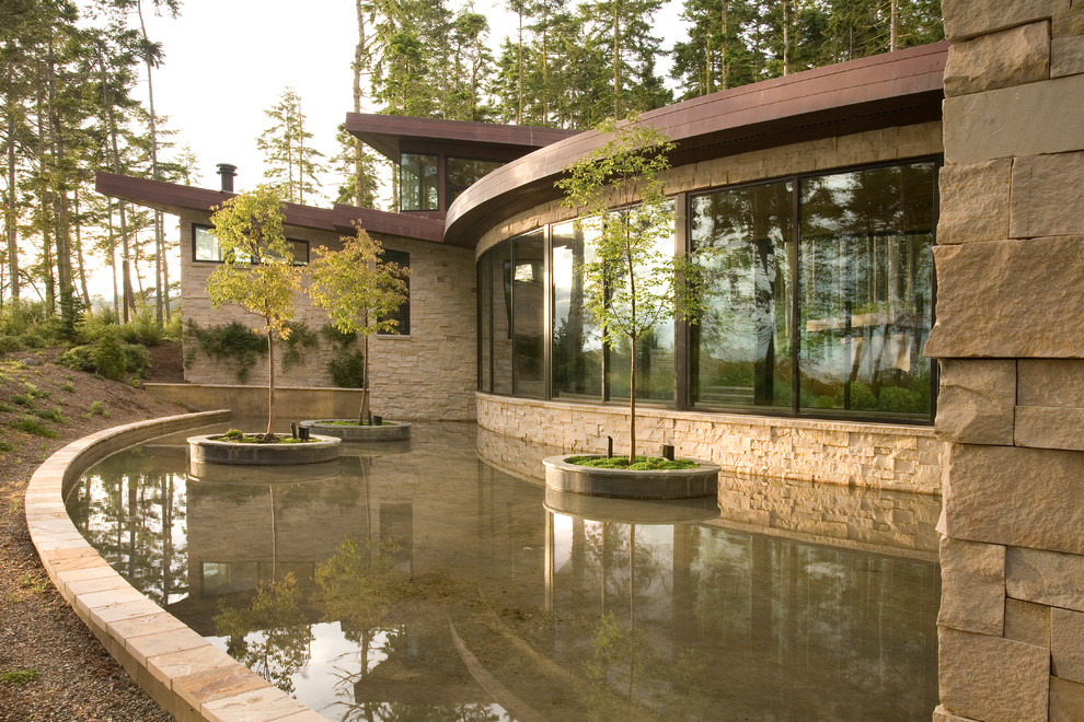 Design ideas for a contemporary house exterior in Seattle with stone cladding.