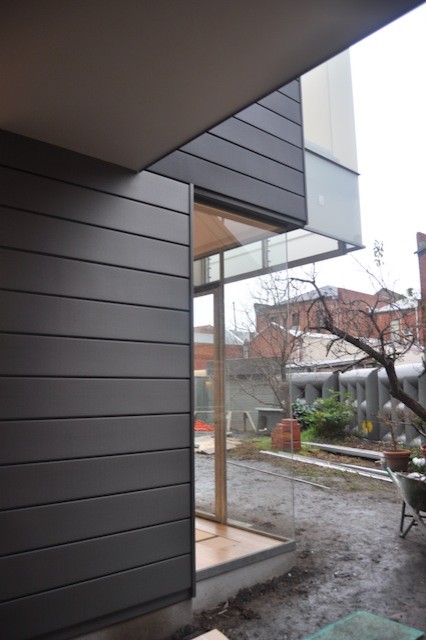Inspiration for a small contemporary black two-story metal flat roof remodel in Melbourne