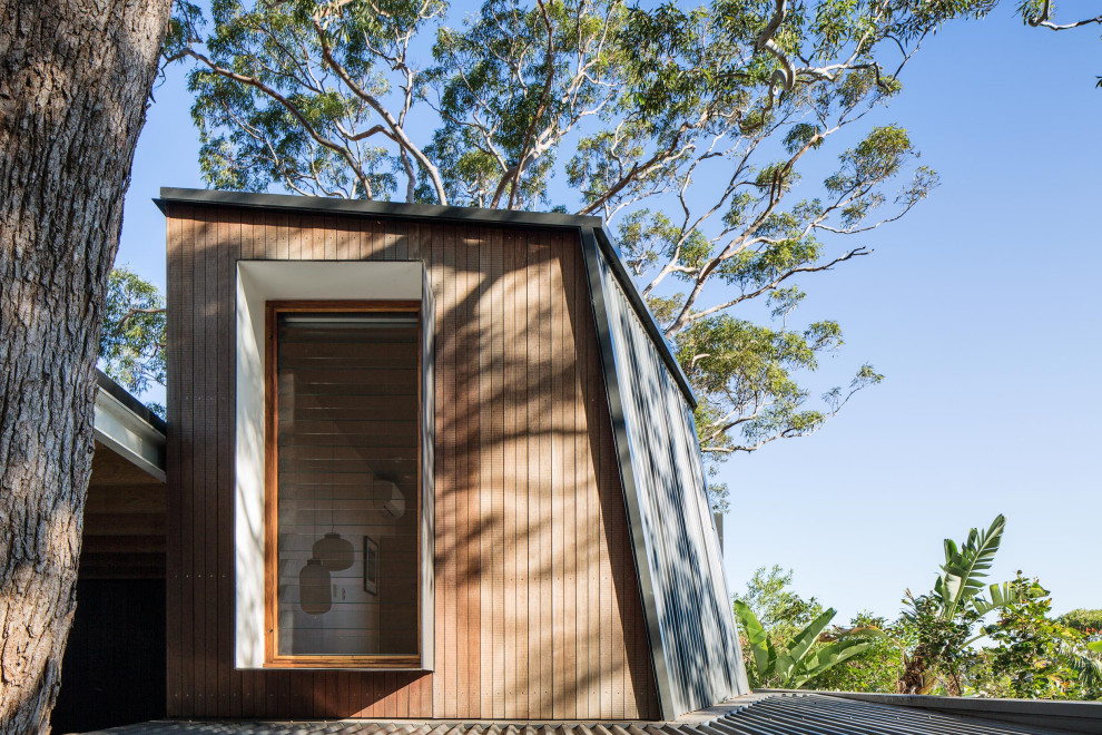 Inspiration for a small contemporary two floor tiny house in Sydney with metal cladding.