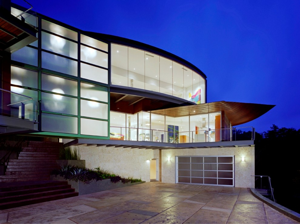 Cette image montre une très grande façade de maison multicolore minimaliste en stuc à deux étages et plus avec un toit plat et un toit en métal.