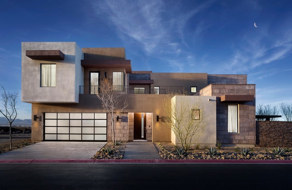 Réalisation d'une grande façade de maison grise minimaliste à un étage avec un revêtement mixte et un toit plat.