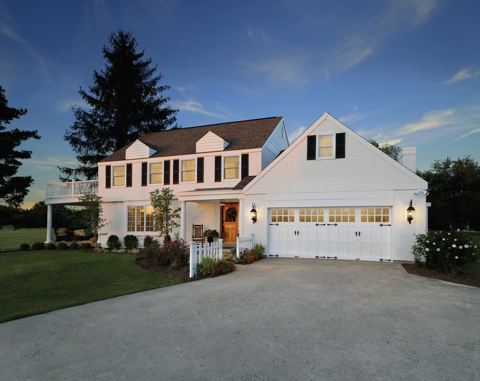 Inspiration for a large timeless white two-story brick house exterior remodel in Cedar Rapids