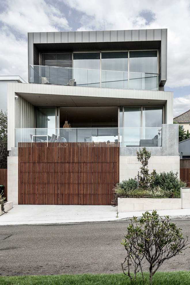 Beige contemporary house exterior in Sydney with three floors and mixed cladding.