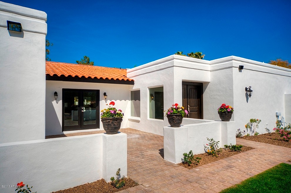 Design ideas for a medium sized mediterranean bungalow render house exterior in Phoenix.