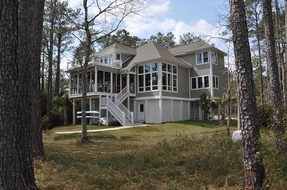 Design ideas for a gey nautical house exterior in Raleigh with three floors.