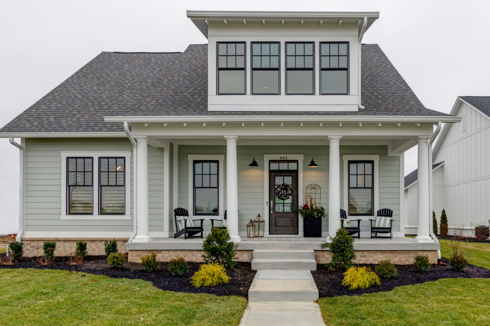 Example of a mid-sized transitional blue two-story vinyl house exterior design in Indianapolis with a shingle roof