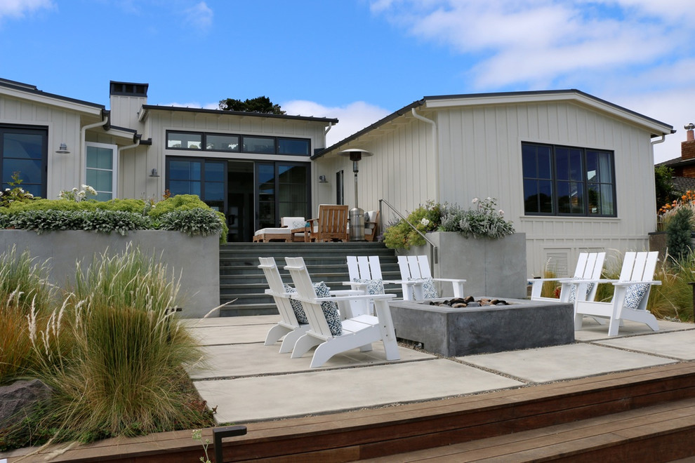 White country bungalow detached house in San Francisco with wood cladding, a pitched roof and a metal roof.