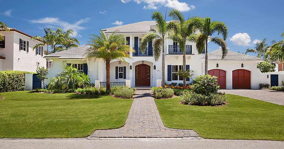 Inspiration for a large transitional white two-story stucco exterior home remodel in Miami
