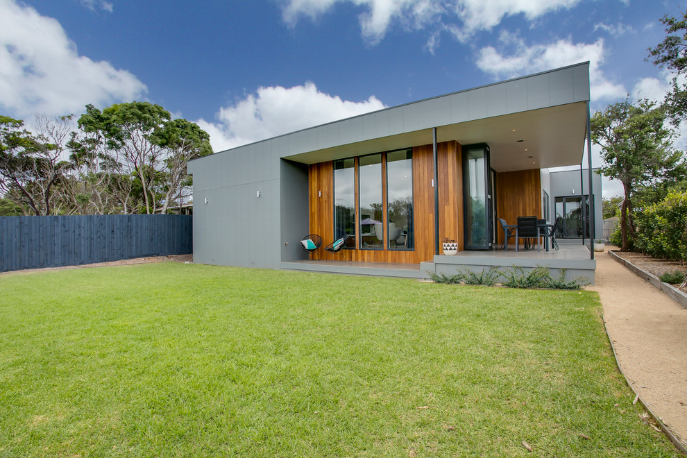 This is an example of a beach style house exterior in Melbourne with concrete fibreboard cladding.