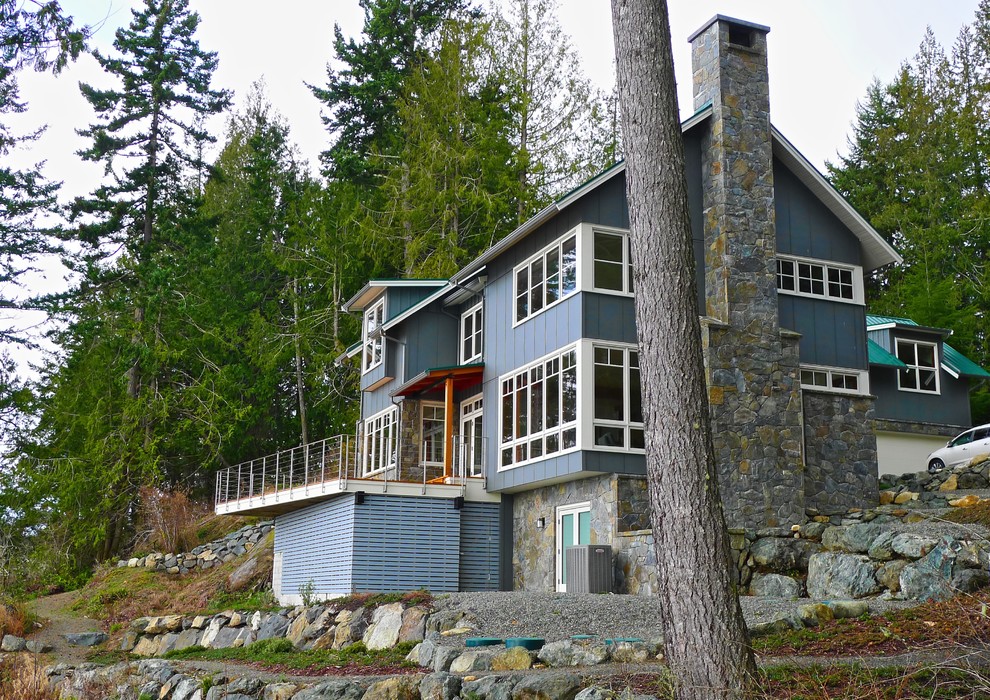 Example of a mid-sized beach style blue three-story wood gable roof design in Vancouver