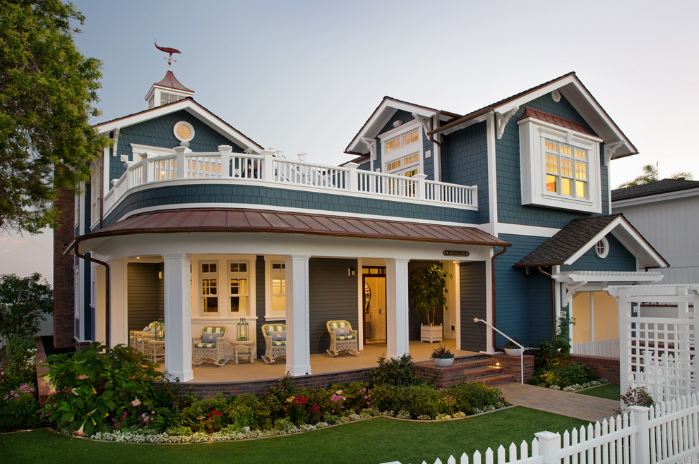 Photo of a blue nautical two floor house exterior in San Diego with a pitched roof and a mixed material roof.