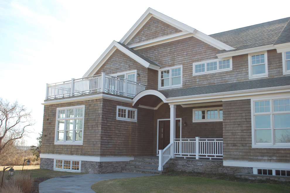 This is an example of a large nautical two floor detached house in Providence with wood cladding, a pitched roof and a shingle roof.