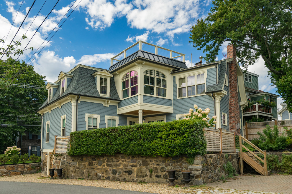 Inspiration for a mid-sized victorian blue two-story wood house exterior remodel in Boston with a shingle roof