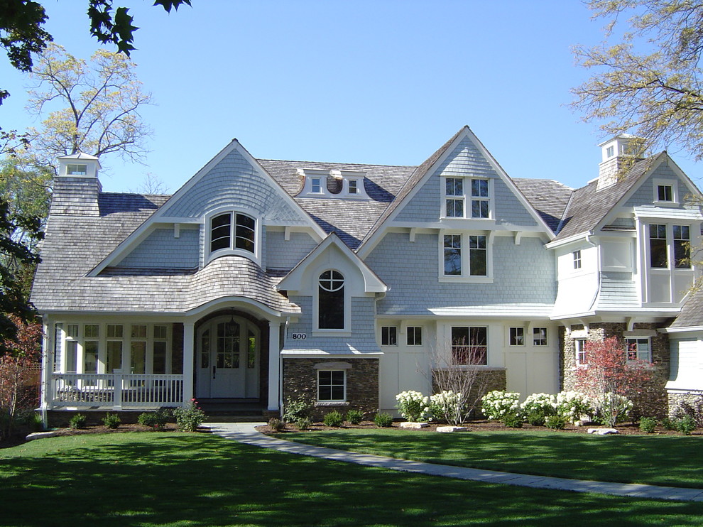 Aménagement d'une grande façade de maison bleue classique à un étage avec un revêtement mixte.