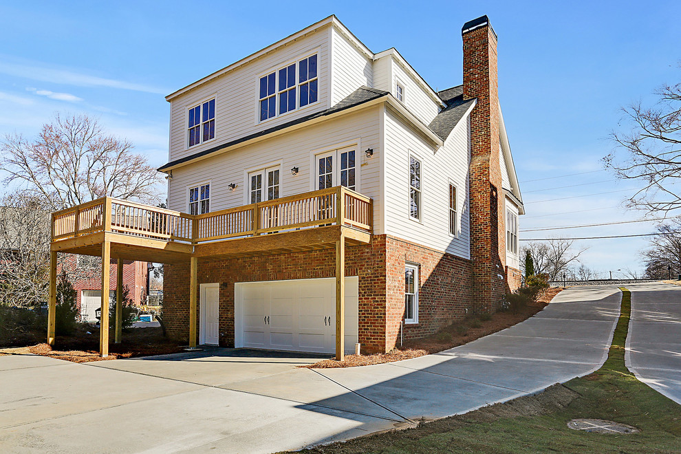 Photo of a white traditional house exterior in Atlanta with three floors.