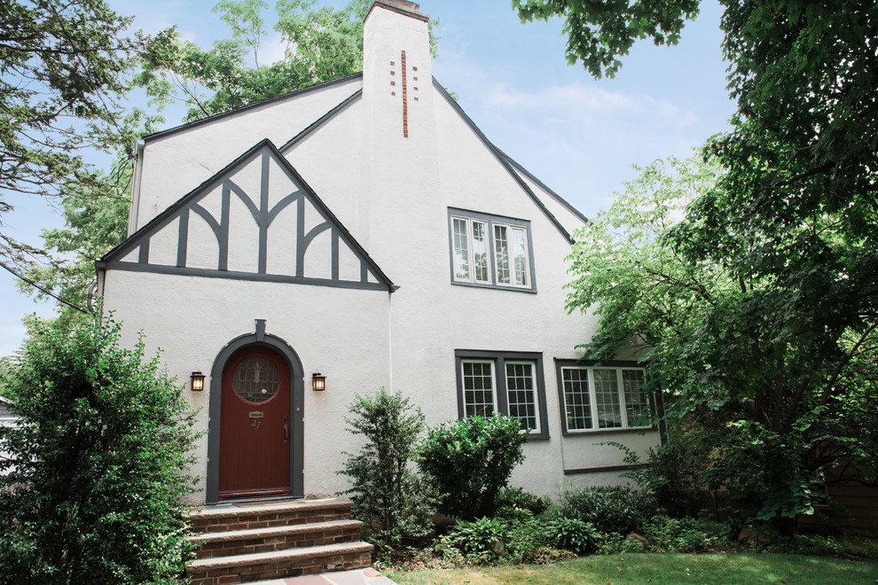 Inspiration for a mid-sized transitional white two-story stucco exterior home remodel in New York