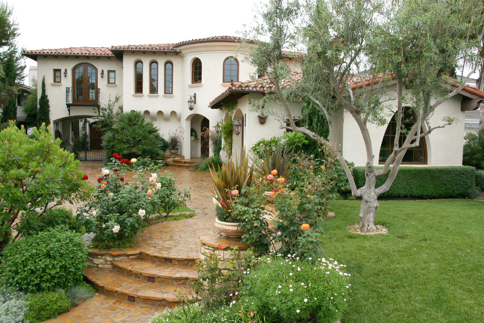 Inspiration for a mediterranean two-story exterior home remodel in Orange County