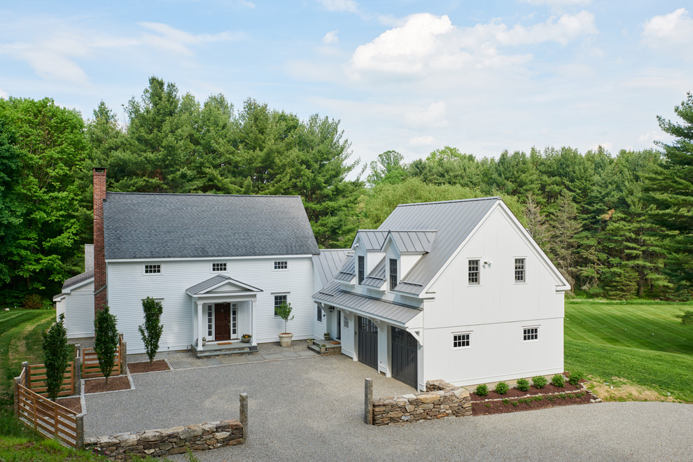 Farmhouse white two-story exterior home photo in New York with a mixed material roof