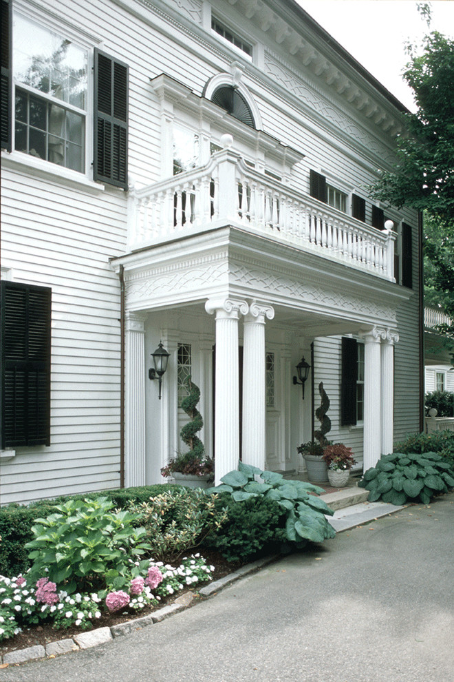 Inspiration for a large timeless white two-story wood exterior home remodel in Boston with a hip roof