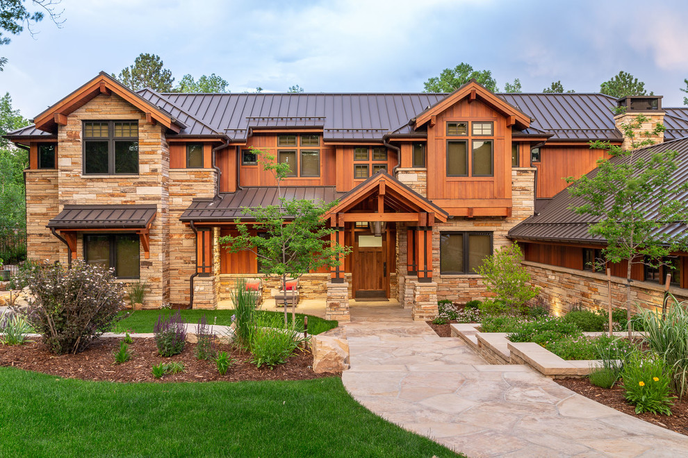 Example of a mountain style brown two-story mixed siding exterior home design in Denver with a metal roof